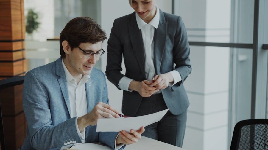 Two professionals reviewing an existing insurance policy
